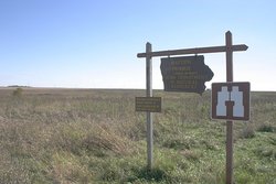 The above sign with the prairie behind it