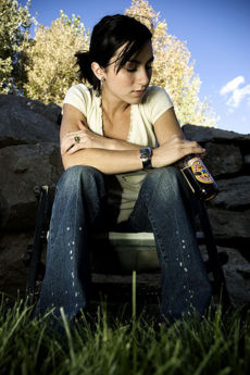 A girl ruminating on whether she would drink that delicious Newcastle her friend left behind.